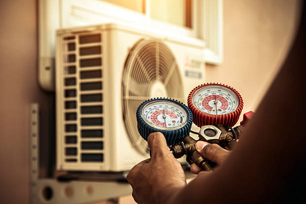 Professional Air Conditioning Service technician working in Sutton, MA